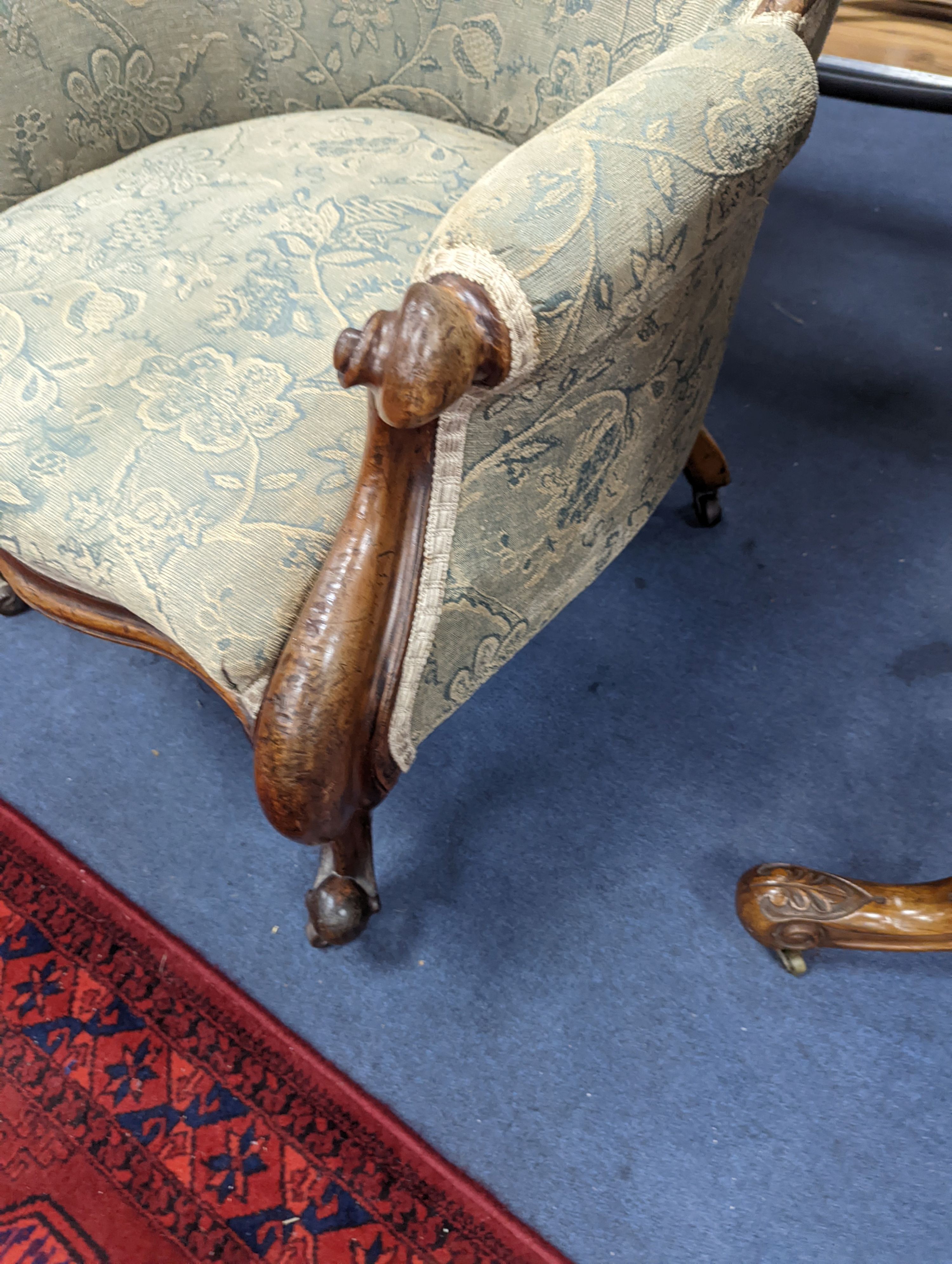 An upholstered Victorian armchair